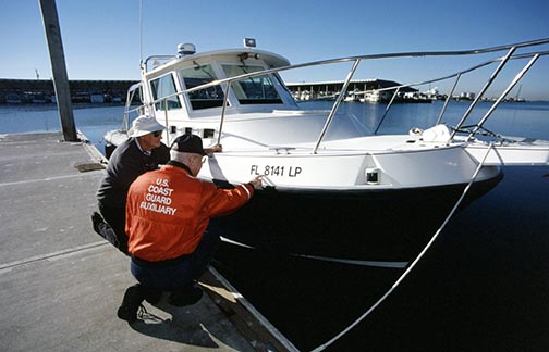 boat registration numbers being checked by the US Coast Guard